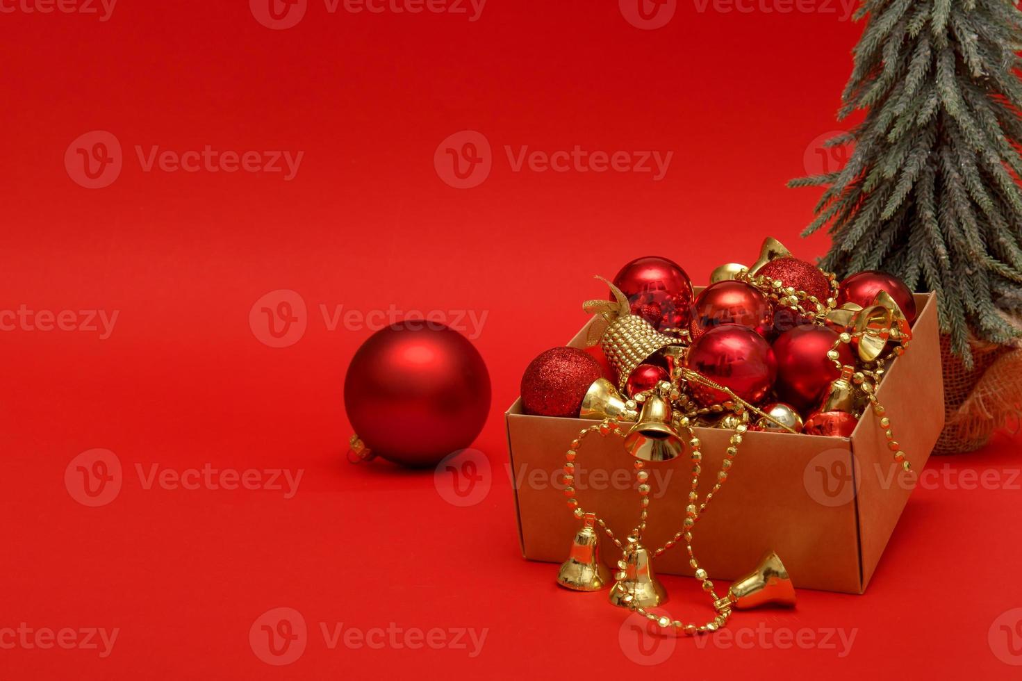 Christmas tree, New Year's toys in a box on a red background with copy space, Christmas, holiday photo