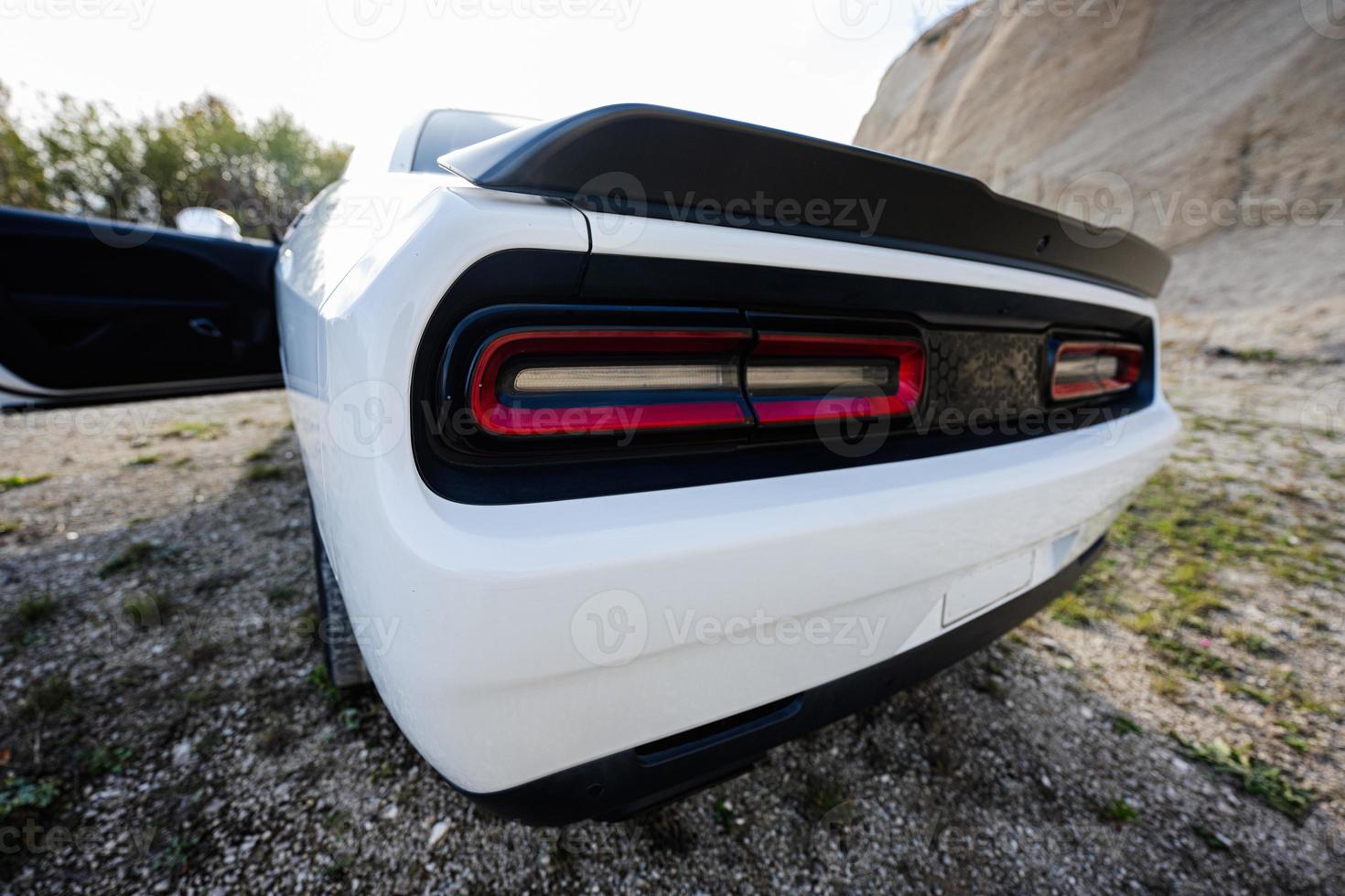 Back lights of white powerfull american muscle car in career. photo