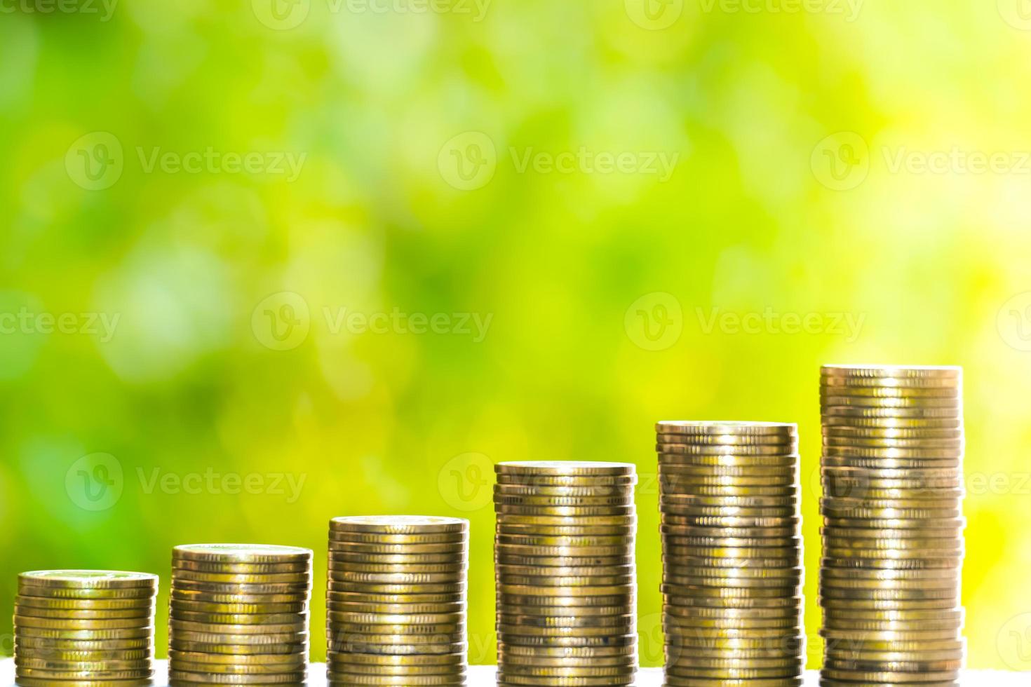 Business Finance and Money concept, Money coin stack growing graph with green tree bokeh background,investment concept photo
