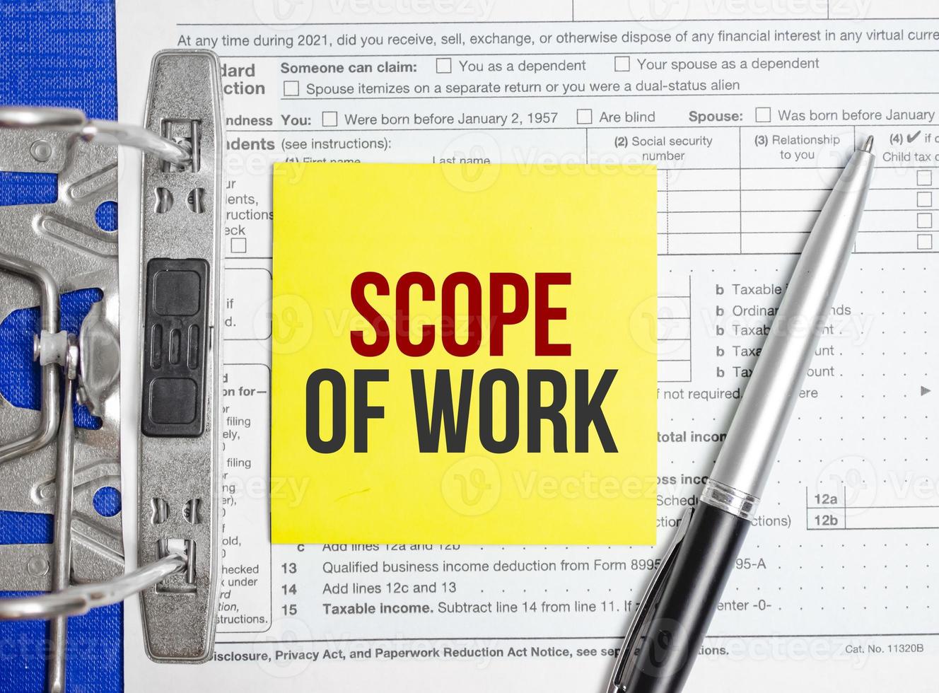 Scope Of Work words on yellow sticker with tax forms and pen photo