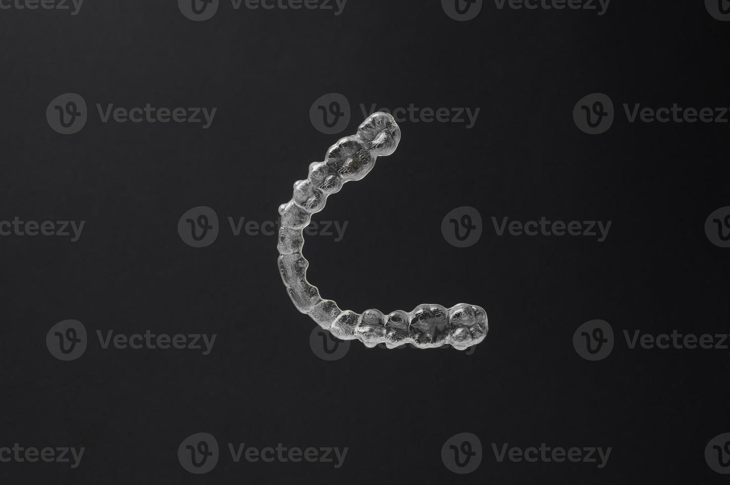 Close-up Invisalign on black background photo