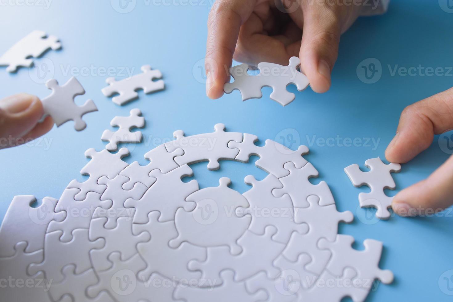 Businessman hand connecting jigsaw puzzle, Business solutions, target, success, goals and strategy concepts photo