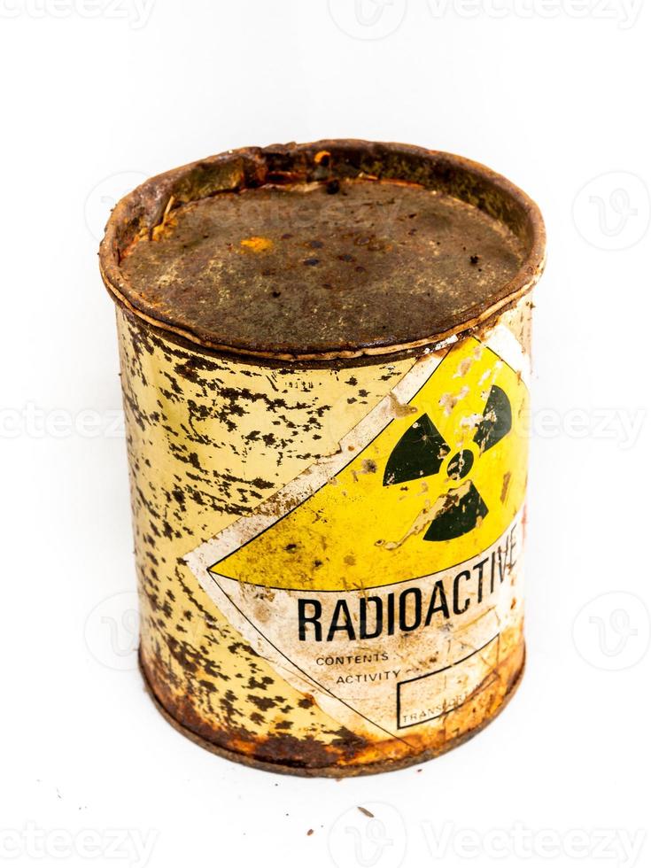 Radiation warning sign on the rusty old cylinder shape container of Radioactive material photo