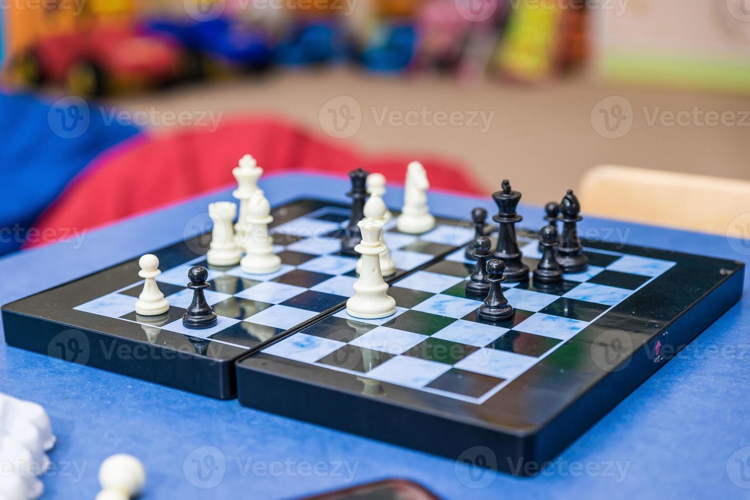 chessboard side view, hand moving a chess piece, about to grab it, closeup. Making a move, strategy, planning, challenge and success abstract lifestyle concept photo