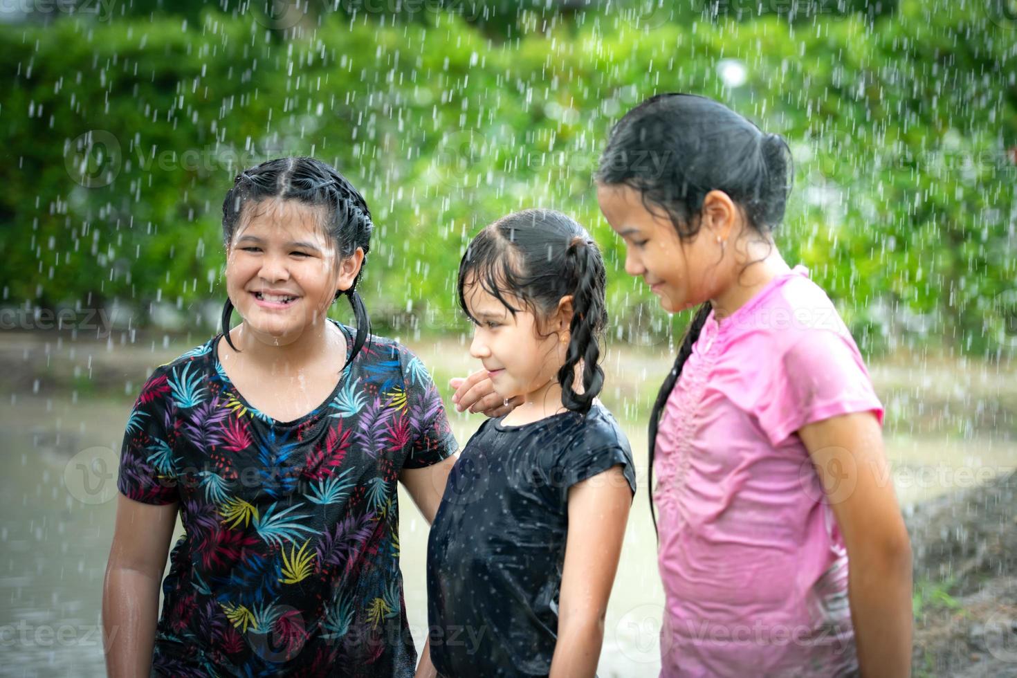 Little girls have fun playing in the mud in the community fields photo