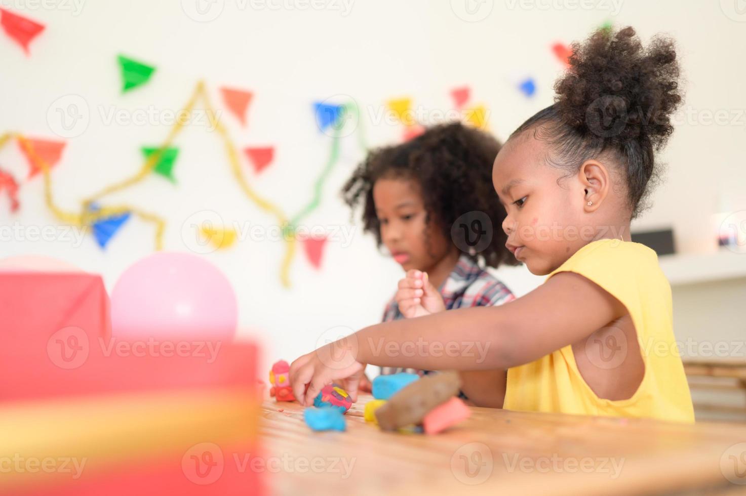 Two little girls Playing with plasticine photo