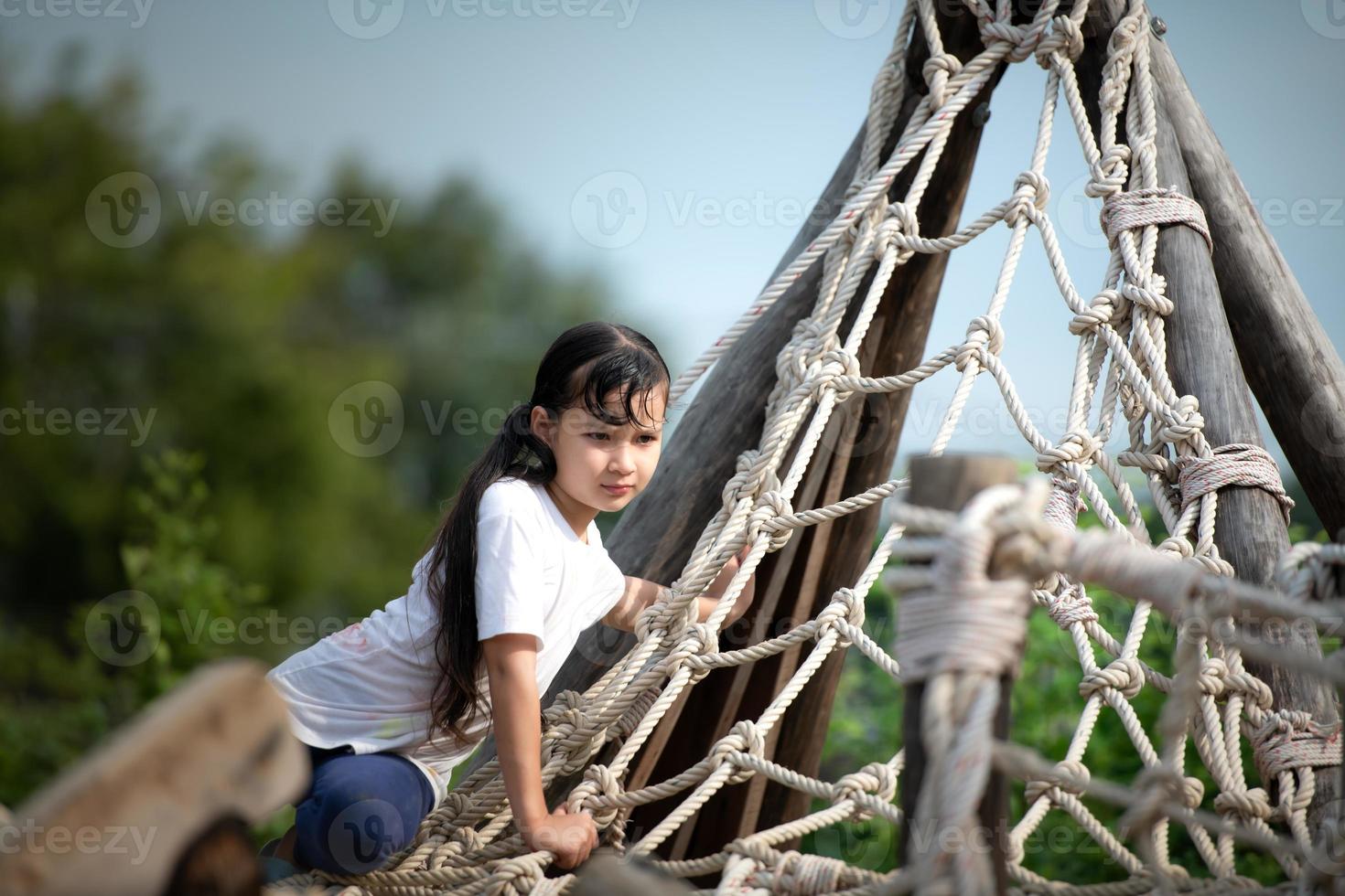 Children have fun playing in the tightrope. with a clear day, a beautiful sky photo