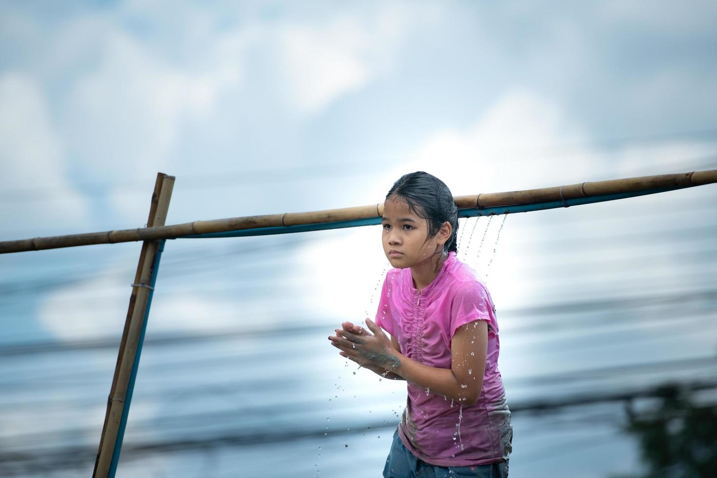 Childrens have fun playing mud slides in the community fields. photo