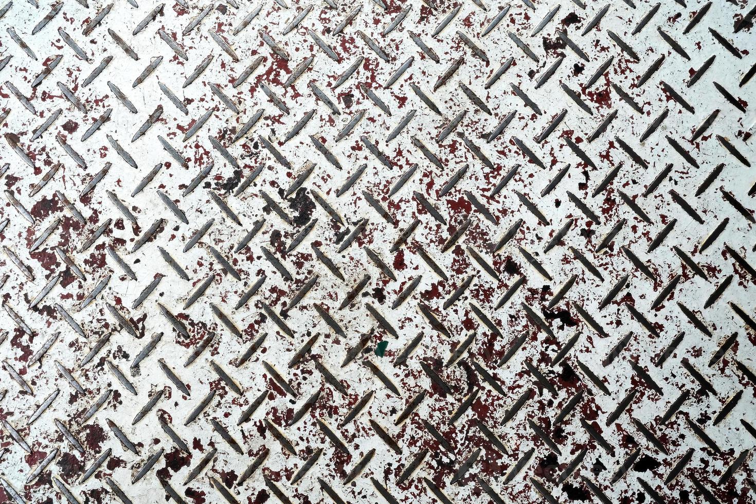 White Grunge Painting on Metal Diamond Plate Texture Background. photo