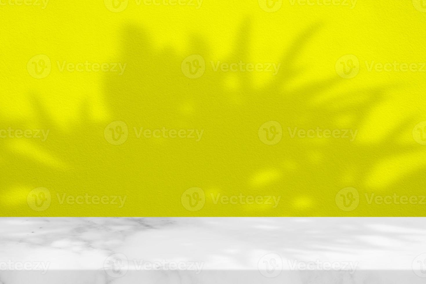 White Marble Table with Tree Shadow on Yellow Concrete Wall Texture Background, Suitable for Product Presentation Backdrop, Display, and Mock up. photo