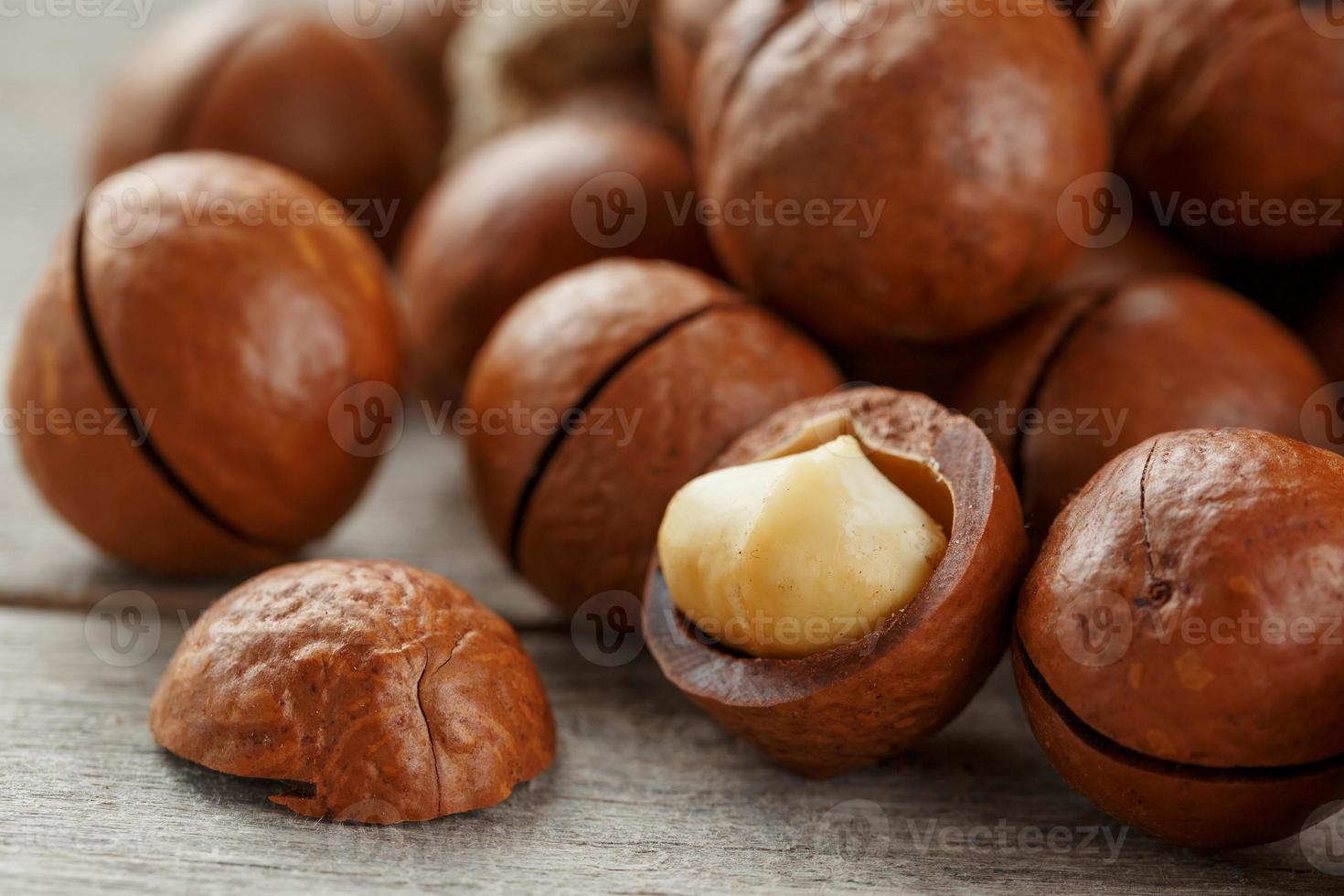 Macadamia nut on a wooden table in a bag, closeup, top view photo