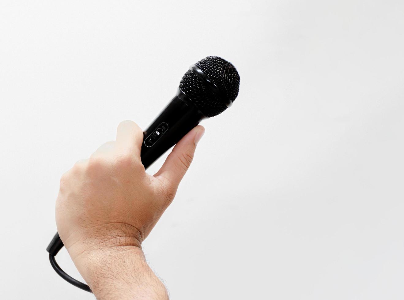 Man with microphone on white background photo