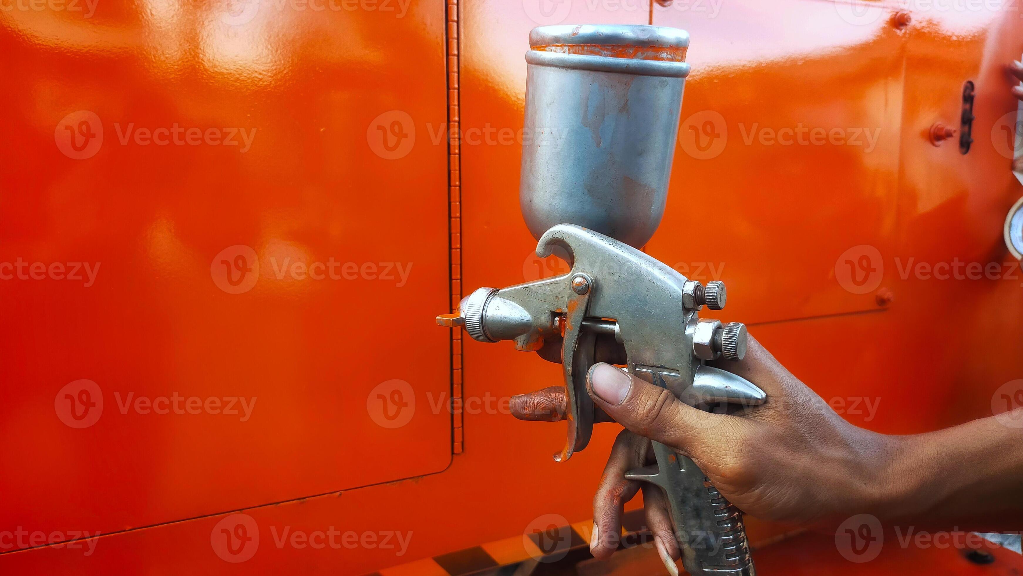 Painting process with a paint gun sprayer. 14325135 Stock Photo at Vecteezy