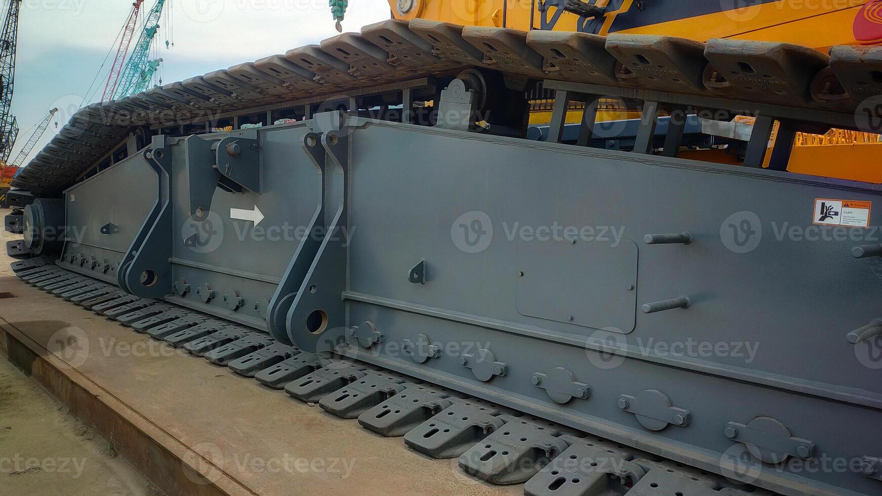 Giant crawler crane undercarriage side track for heavy lifting capacity standing on landing mat for safety used. photo