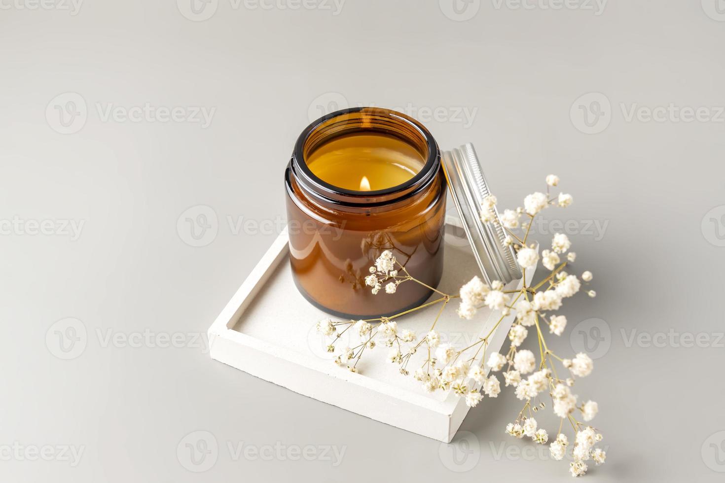 Luxurious white tray decoration, home interior decor with burning aroma candle with white dry flowers photo