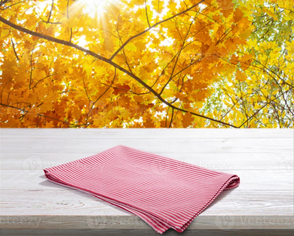 Red napkin on white wooden table top view photo
