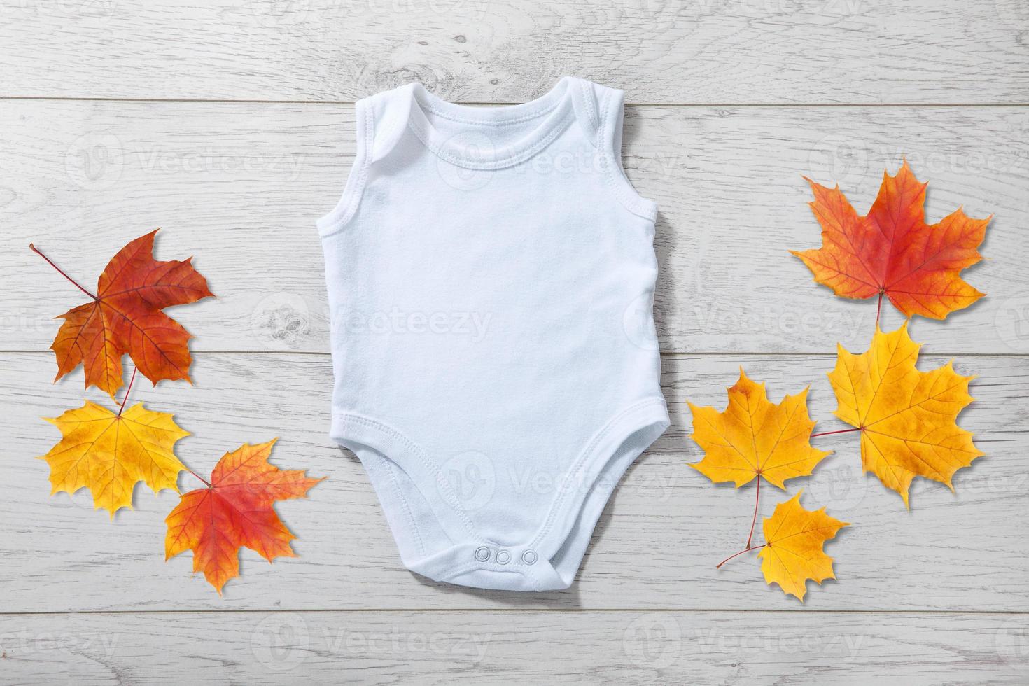 White baby onesie isolated over light wood background. Good for insert your design photo