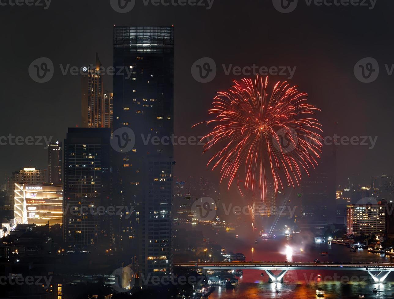 High angle view Fantastic Multicolor Long Exposure shot of Fireworks over Chao Phraya River, Cityscape of Bangkok, Festival, Celebration, Happy New Year, Business Architecture. photo