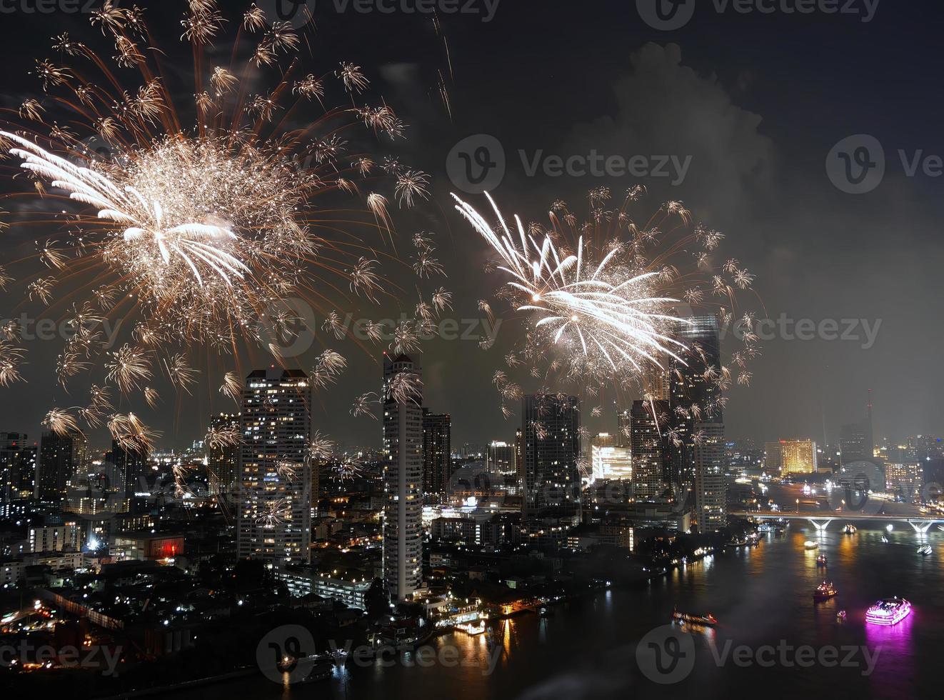 High angle view Fantastic Multicolor Long Exposure shot of Fireworks over Chao Phraya River, Cityscape of Bangkok, Festival, Celebration, Happy New Year, Business Architecture. photo