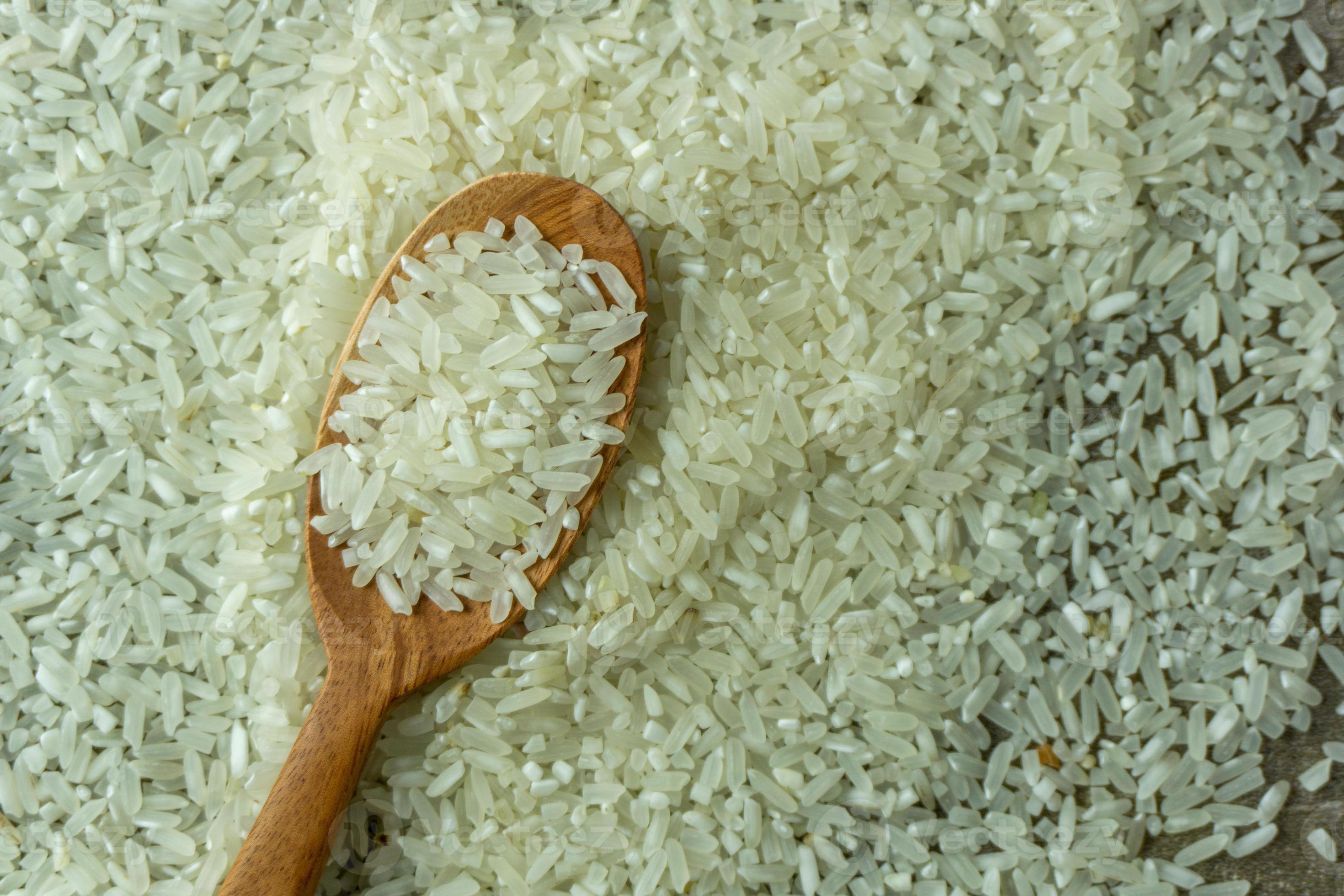 dry-rice-or-uncooked-rice-top-angle-view-of-raw-rice-and-wooden-spoon