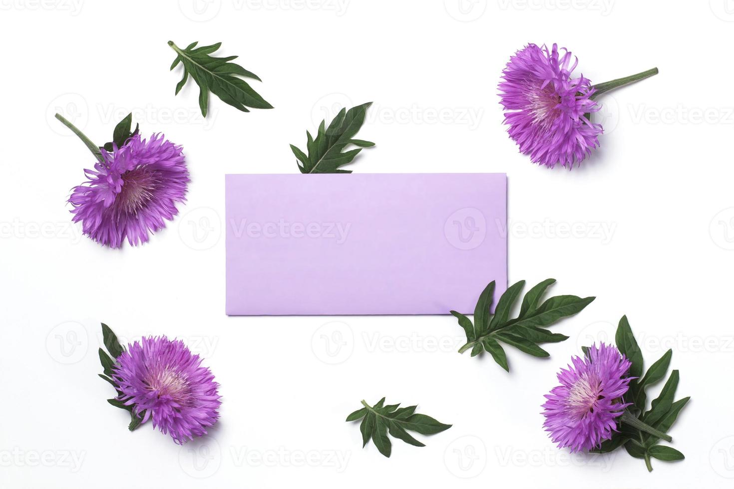 Invitation or greeting card mockup with blank lilac envelope with thistle flowers on white background photo