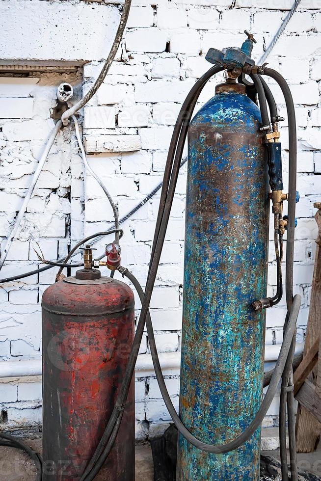 Old gas cylinders for welding and cutting. Rusty propane and oxy photo