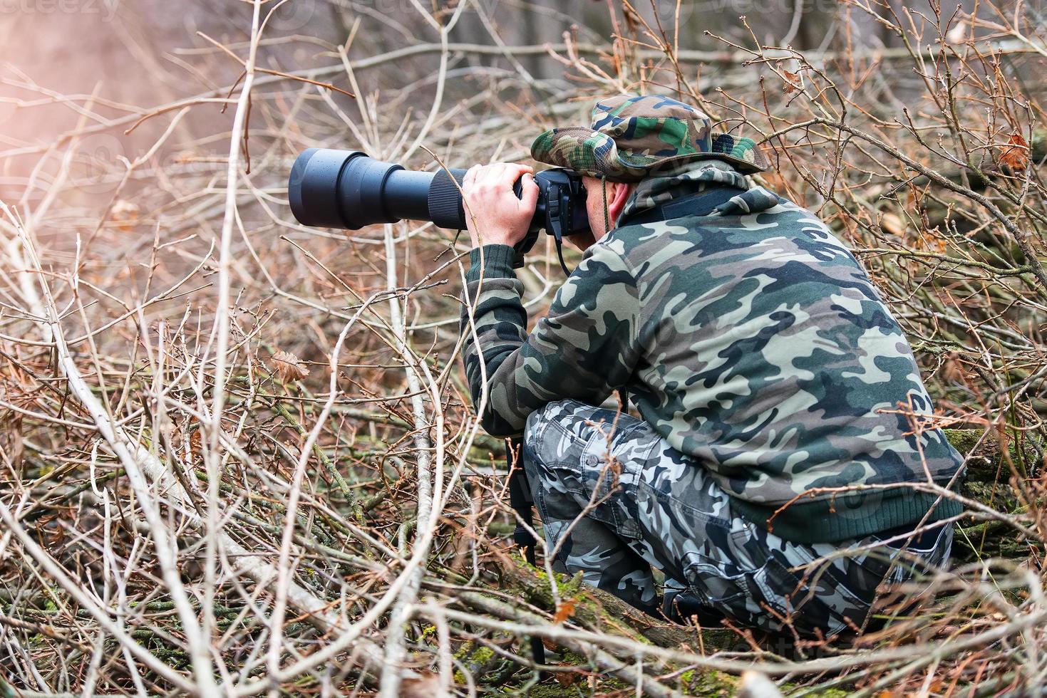 Photo hunting camouflaged in the branches