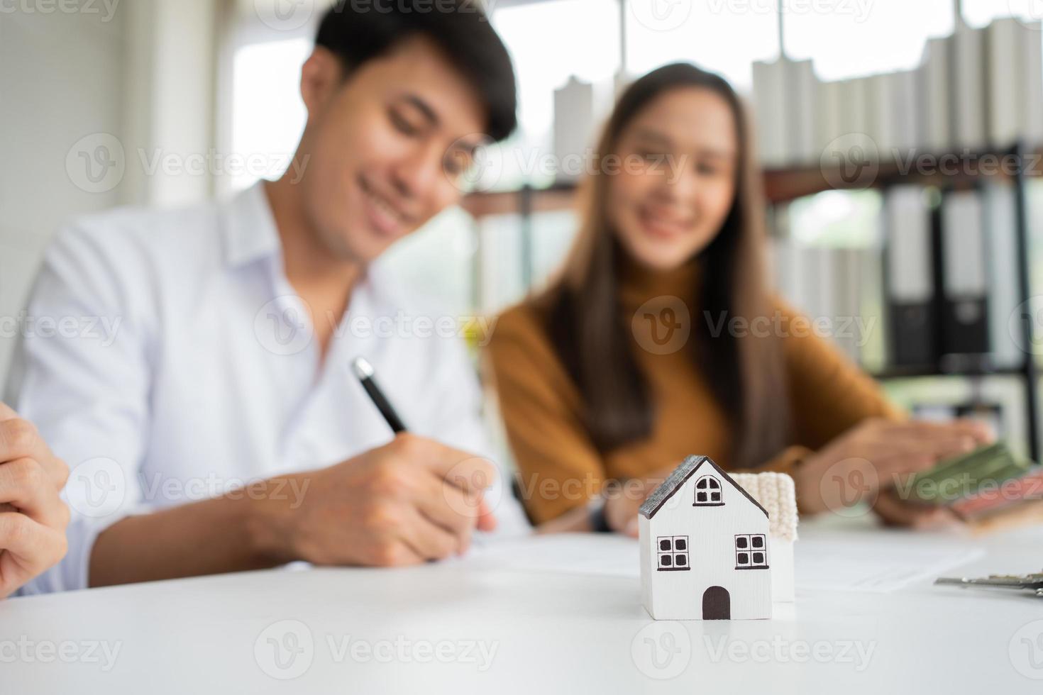 Client signs home loan document to buy homes with real estate property agent or lawyer. Real estate agent and customer signing contract to buy a house. Concept of insurance or loan real estate photo