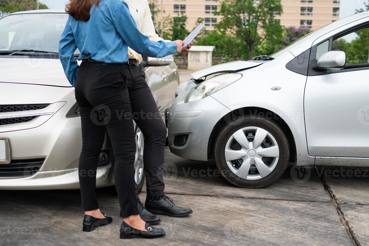 Two Drivers using a smartphone to exchange phone numbers and social media after a car accident. Concept of claim insurance for a car accident online after send photo and evidence to insurance company