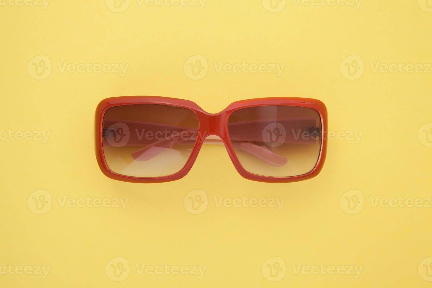 Summer background. Sunglasses isolated on colorful background. Top view and copy space. photo