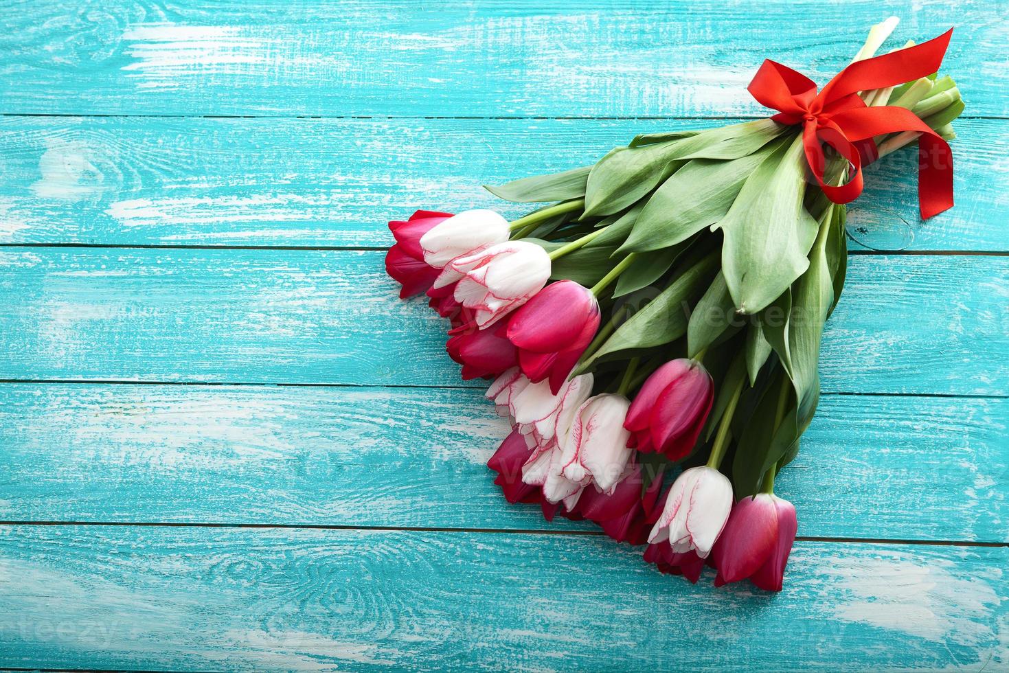 Bouquet of tulips on turquoise rustic wooden background. Spring flowers bouquet. Spring background. Valentine's Day and Mother's Day background. photo