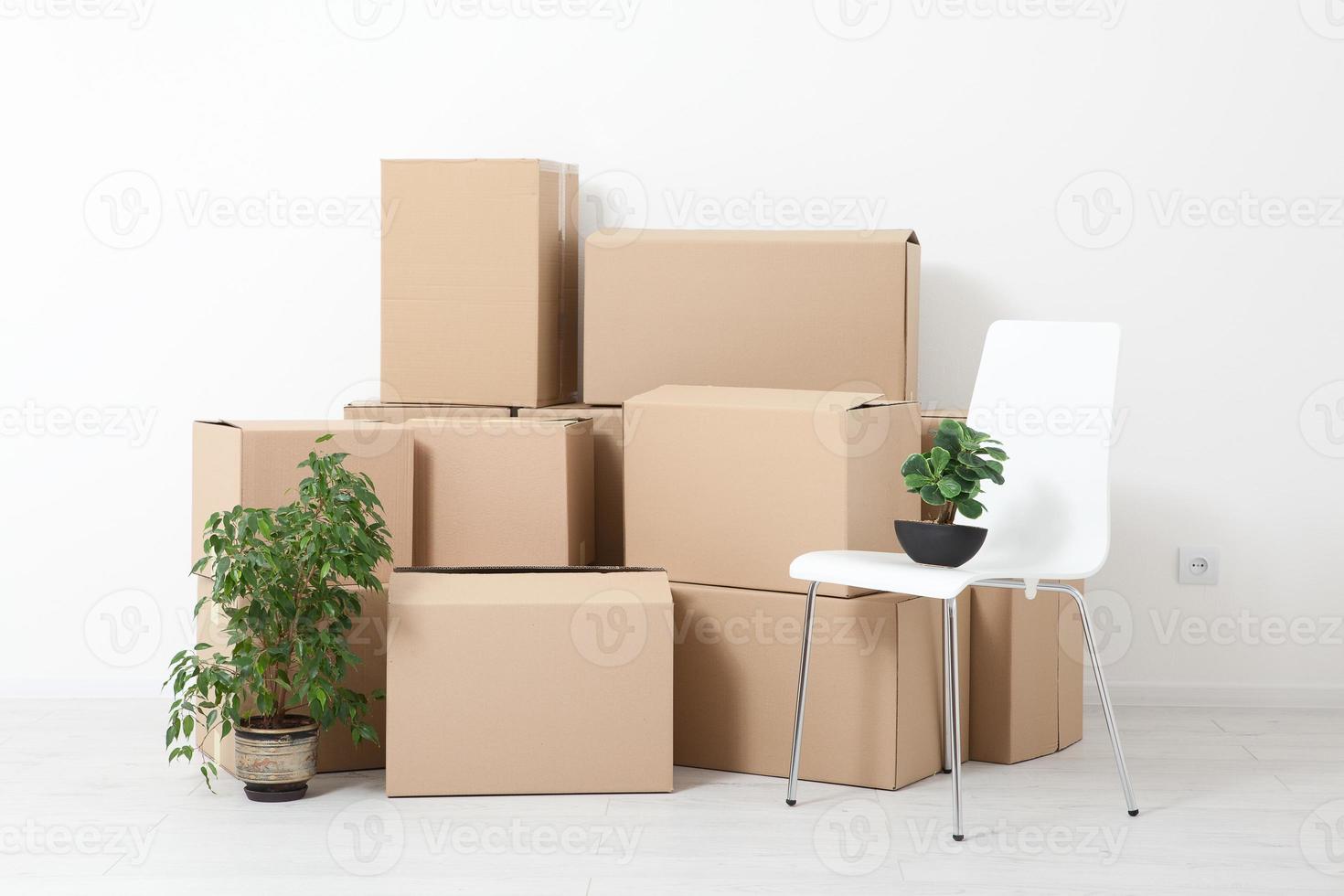 Moving into a new apartment. Move lots of cardboard boxes in an empty new apartment. photo