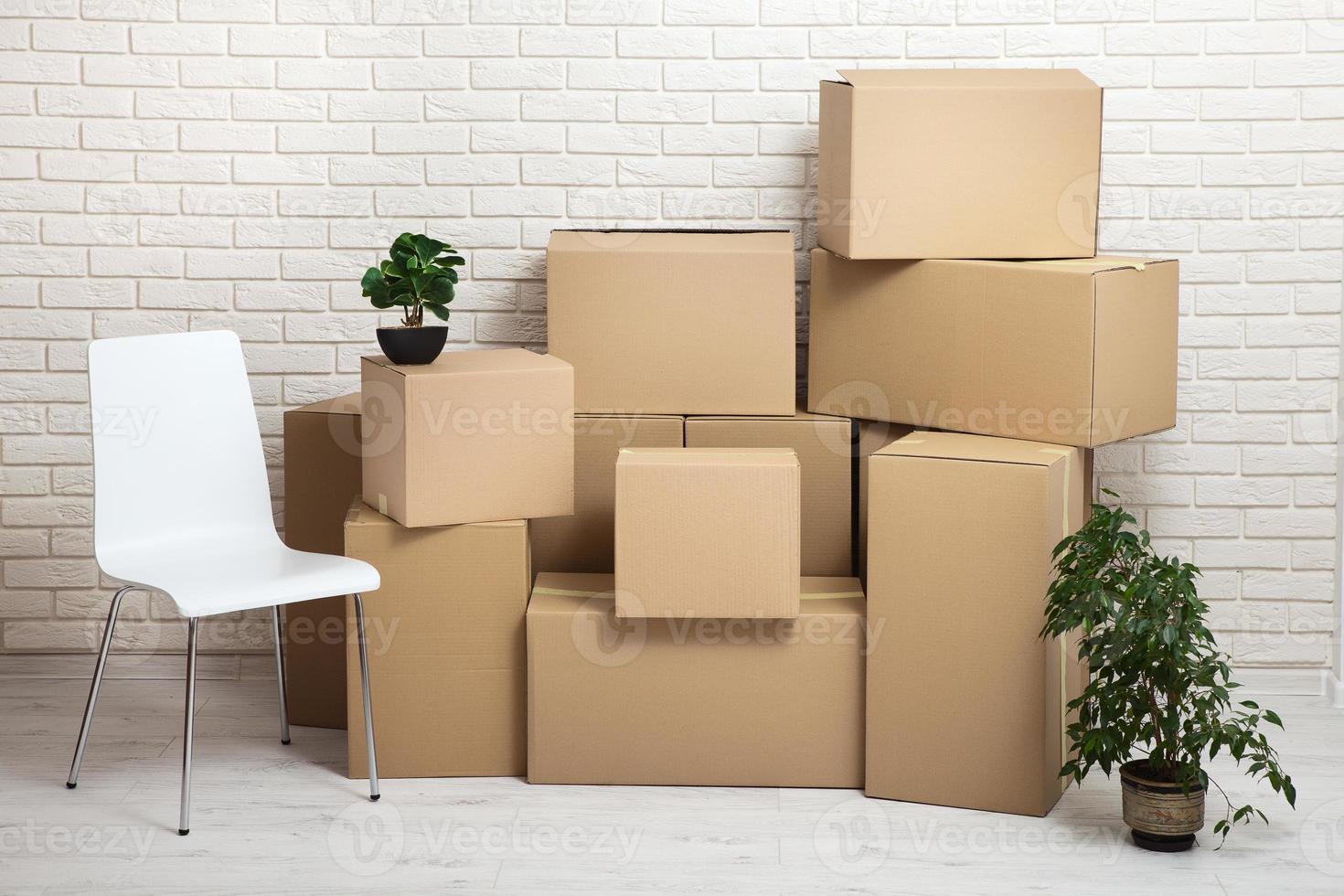 Moving into a new apartment. Move lots of cardboard boxes in an empty new apartment. photo