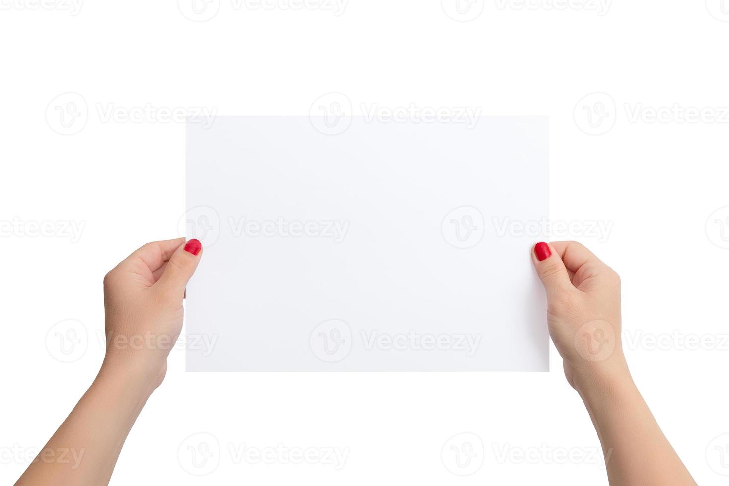 Girl's hands hold a blank paper in a horizontal position. Isolated background in white. Clean paper for copy presentation photo