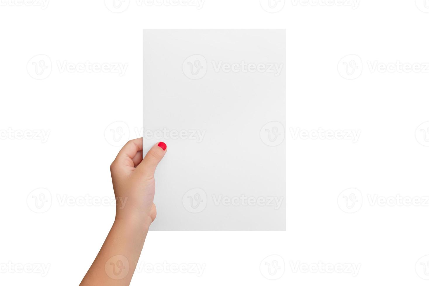 Isolated girl's hand hold a blank paper in a vertical position. Copy presentation mockup photo