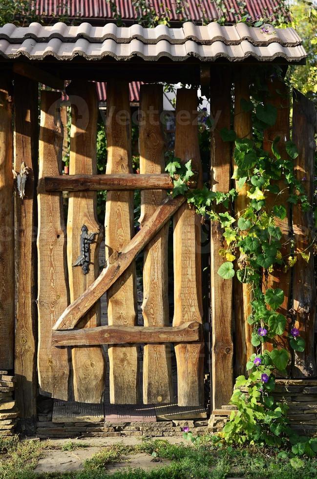 Wooden old fence with a wicket photo