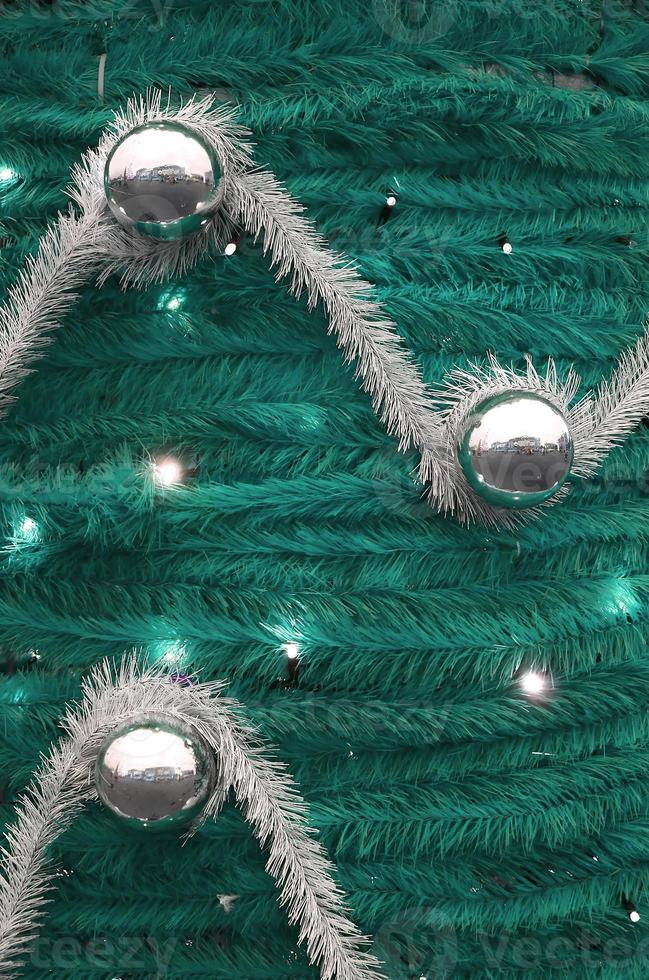Texture of the wall decorated with New Year's fluffy ribbons and decorations in the form of glossy balls photo