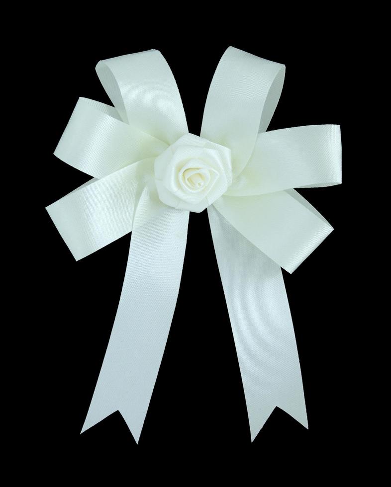 White satin gift bow. Ribbon. Isolated on black with clipping path photo