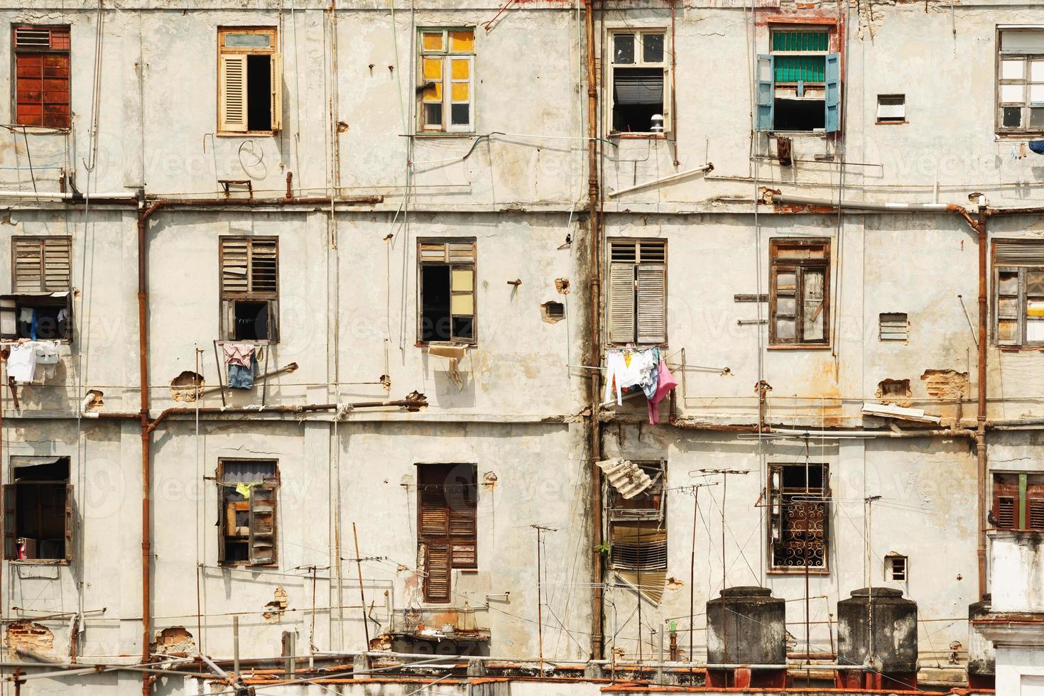 Old shabby residential building in Havana slums photo