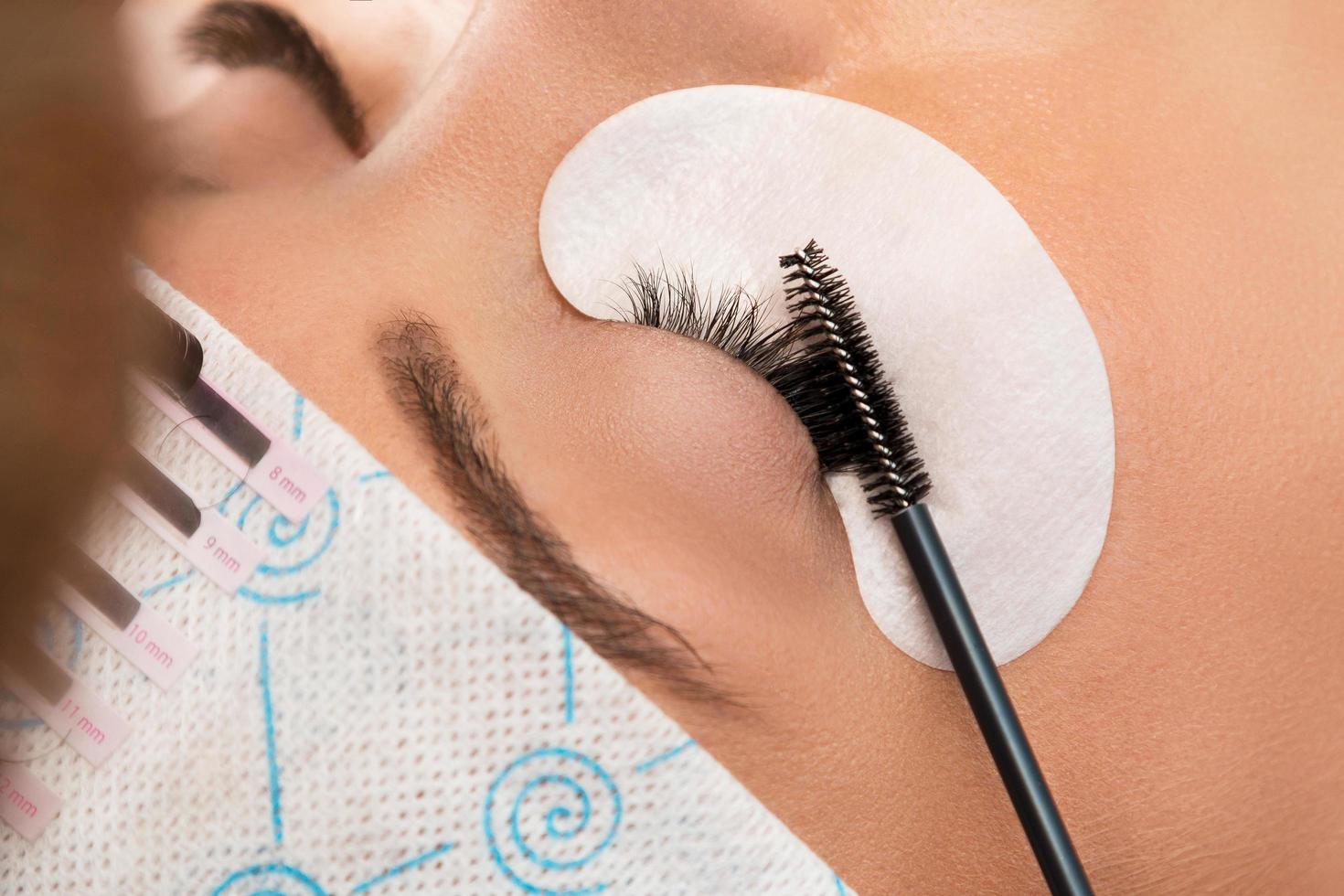 Procedure of eyelashes extension in beauty salon photo
