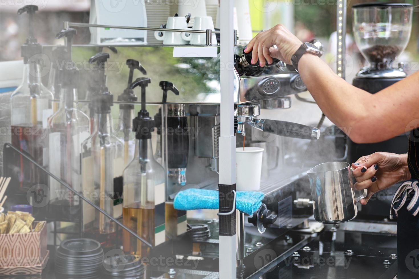 Barista is preparing delicious coffee with milk photo