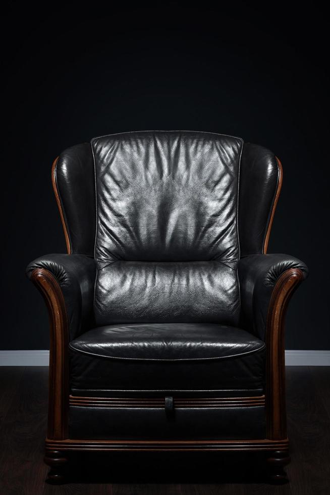 Big Leather armchair in dark interior room photo