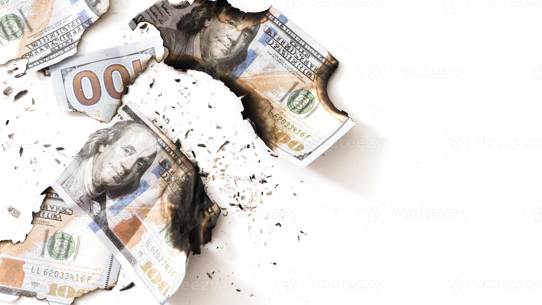 Remainings of a burnt out dollar bills reduced to ashes after a fire. photo