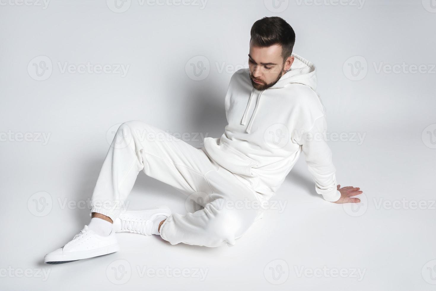 Handsome man wearing blank white hoodie and pants photo