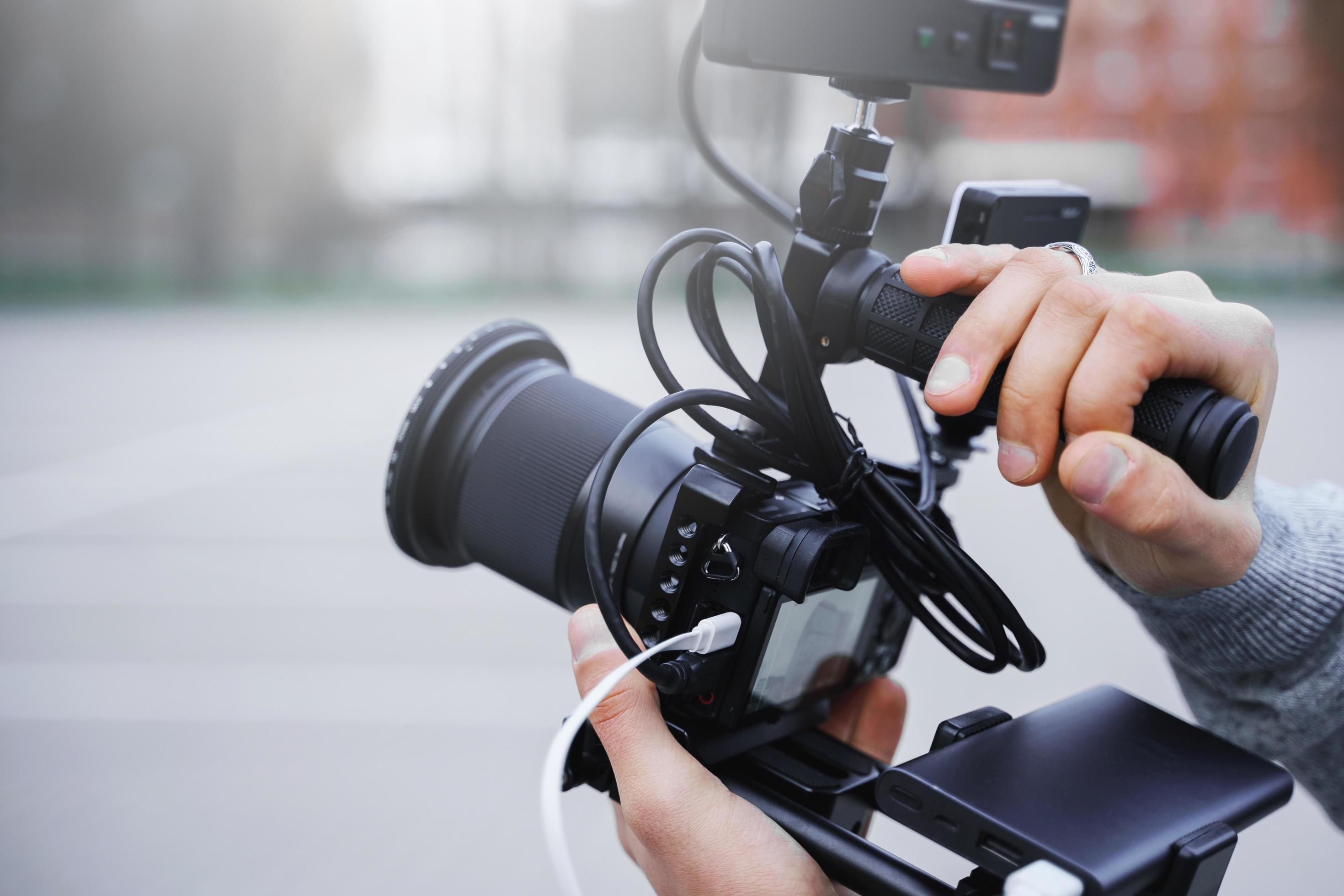 Videographer with a modern mirrorless camera rig 14350056 Stock Photo