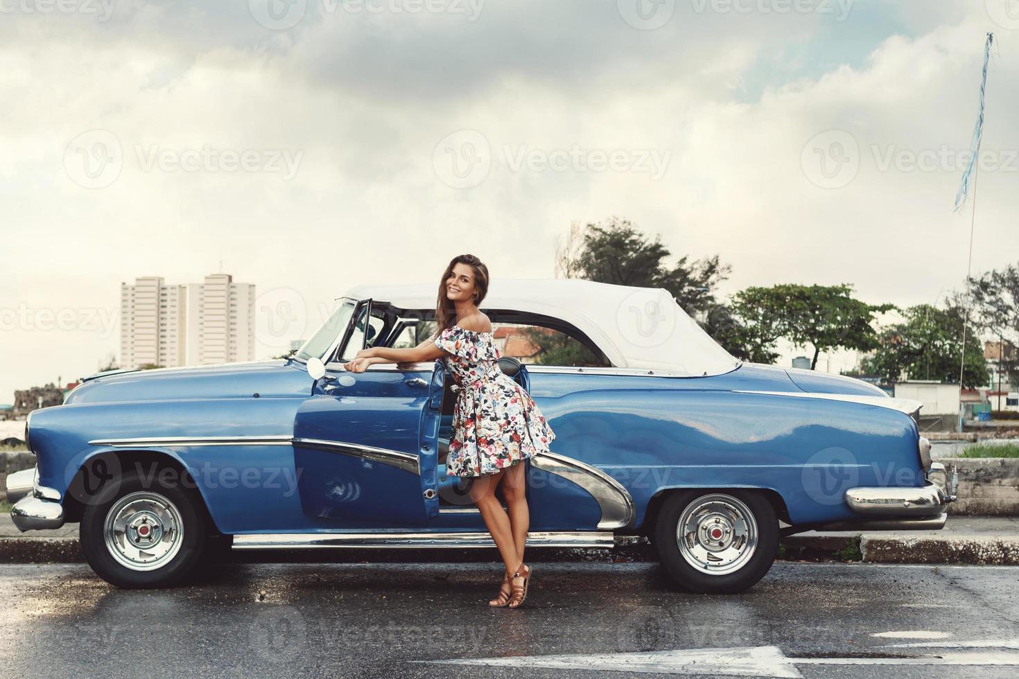 Beautiful woman driving a retro convertible car photo