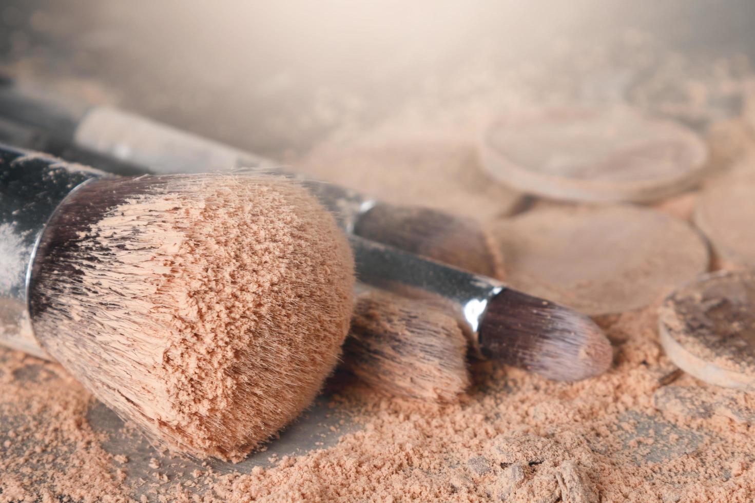 Crushed eyeshadows and make-up brushes photo