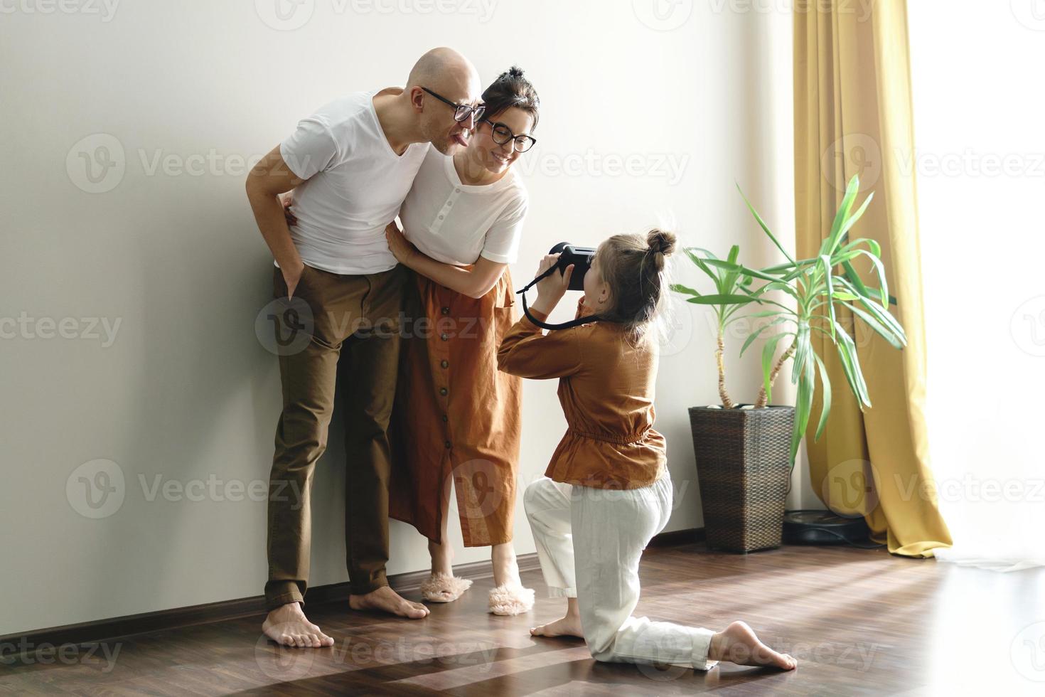 Little daughter taking picture of her parents photo