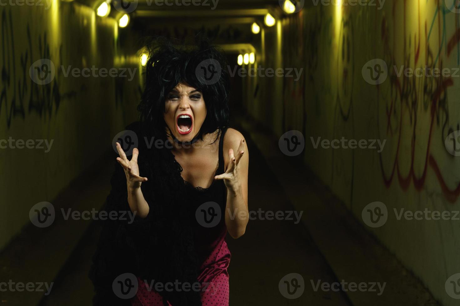 Strange and freaky woman in the dark tunnel photo