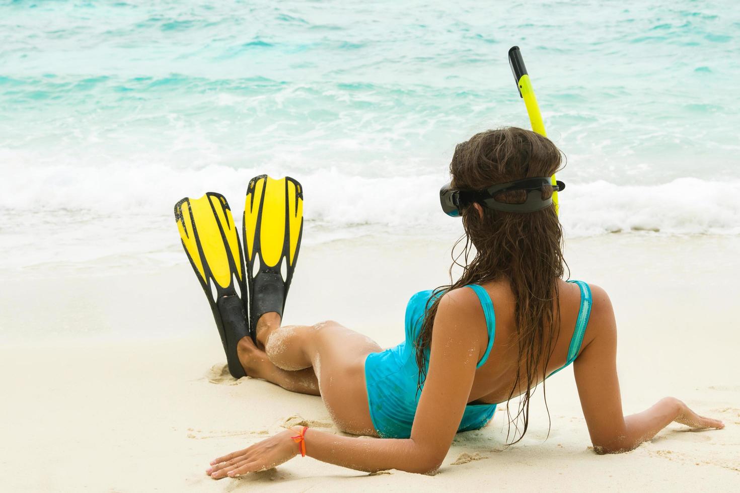 Beautiful young woman after snorkeling on the beach photo